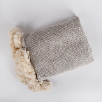 Light throw with pom poms
