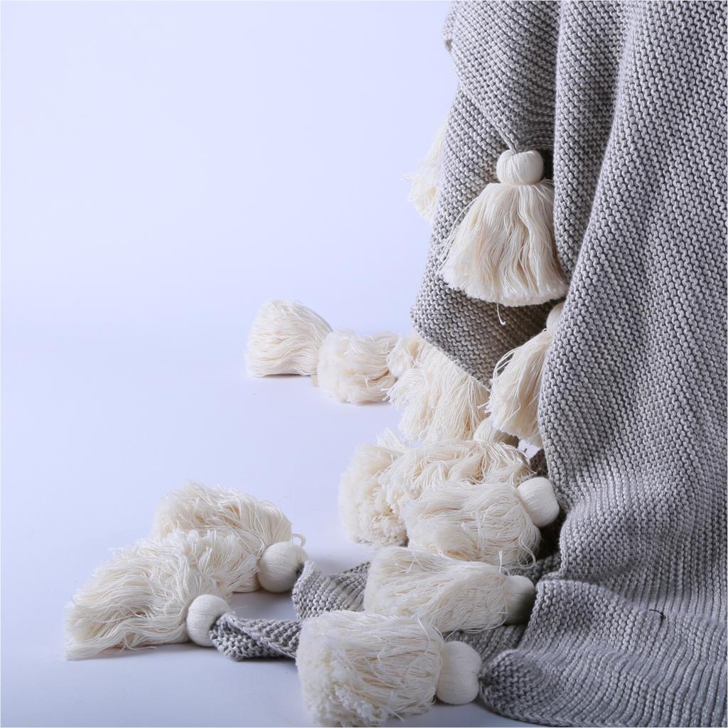 Light throw with pom poms