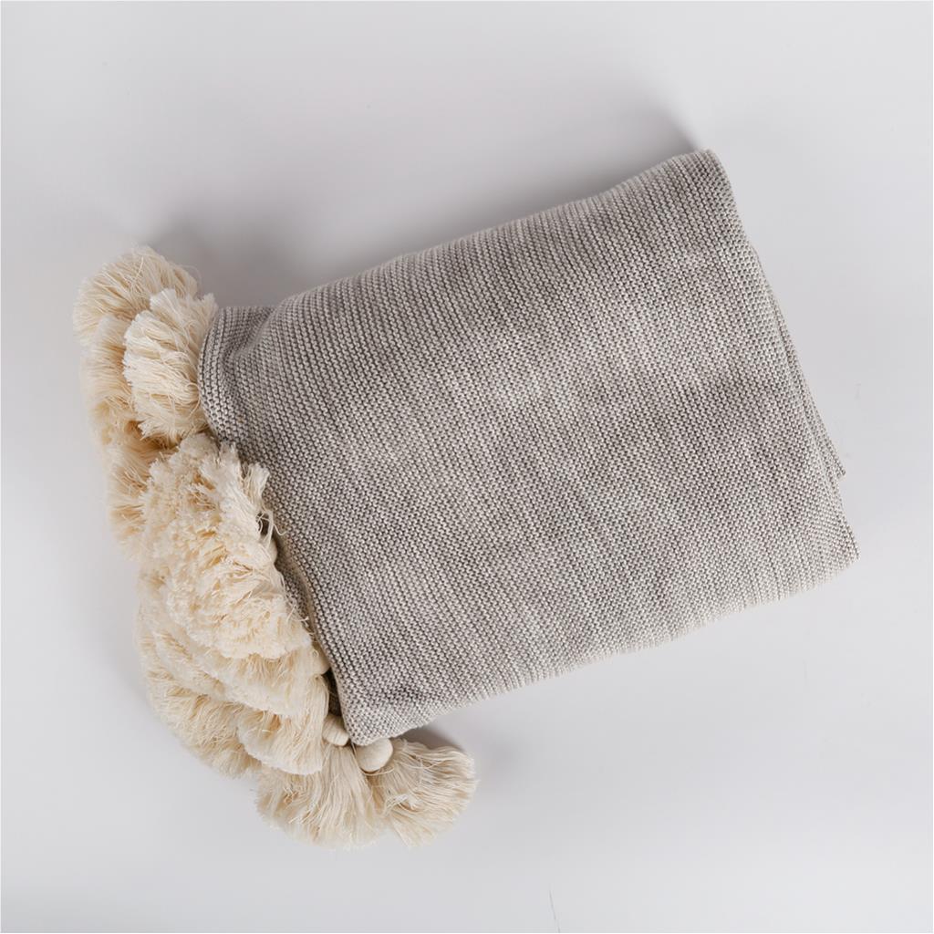 Light throw with pom poms