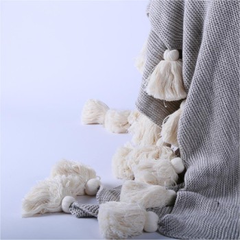 Light throw with pom poms